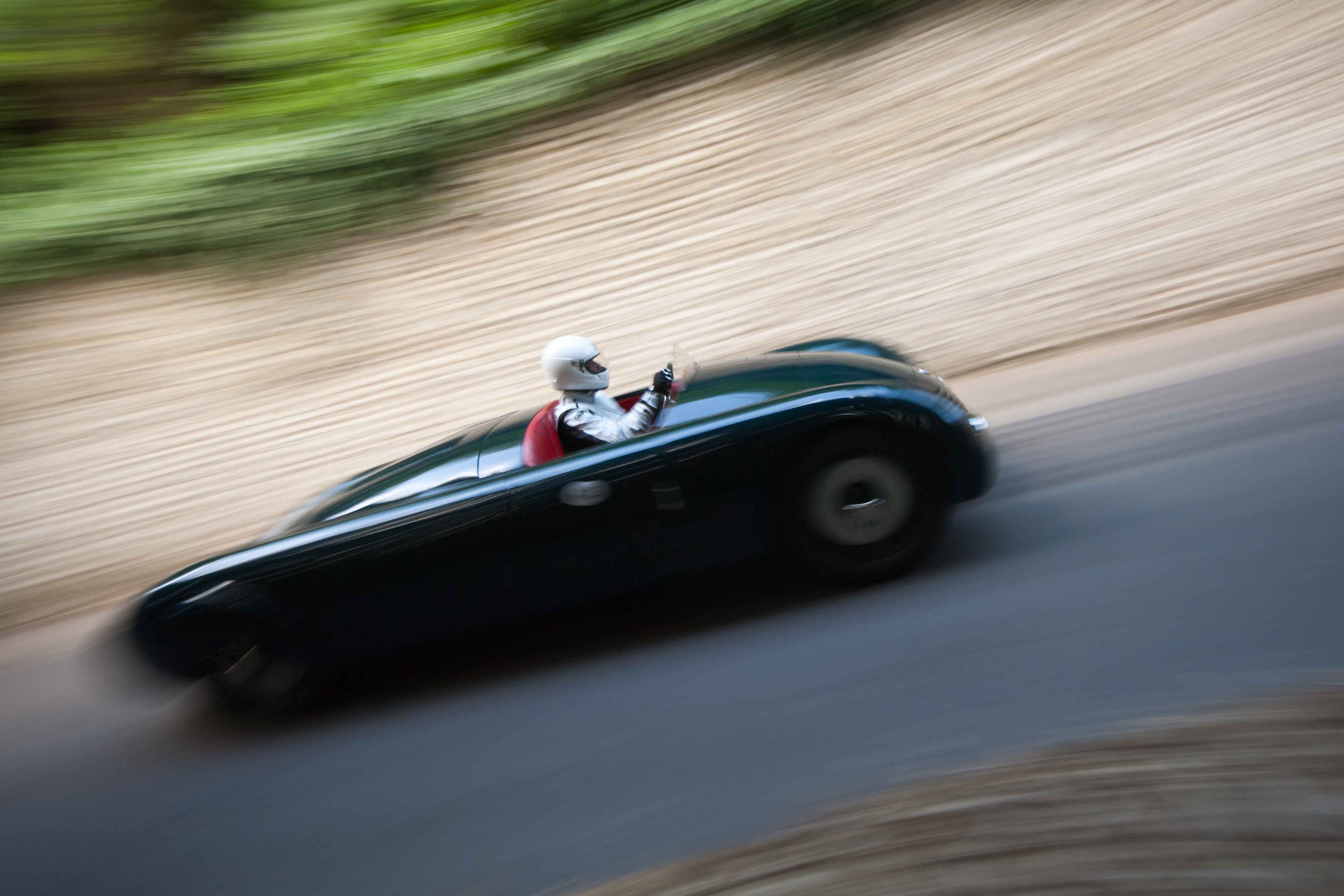The Aero Alfa in superb motion blur past Goodwood's flint wall: by Scott Dennis