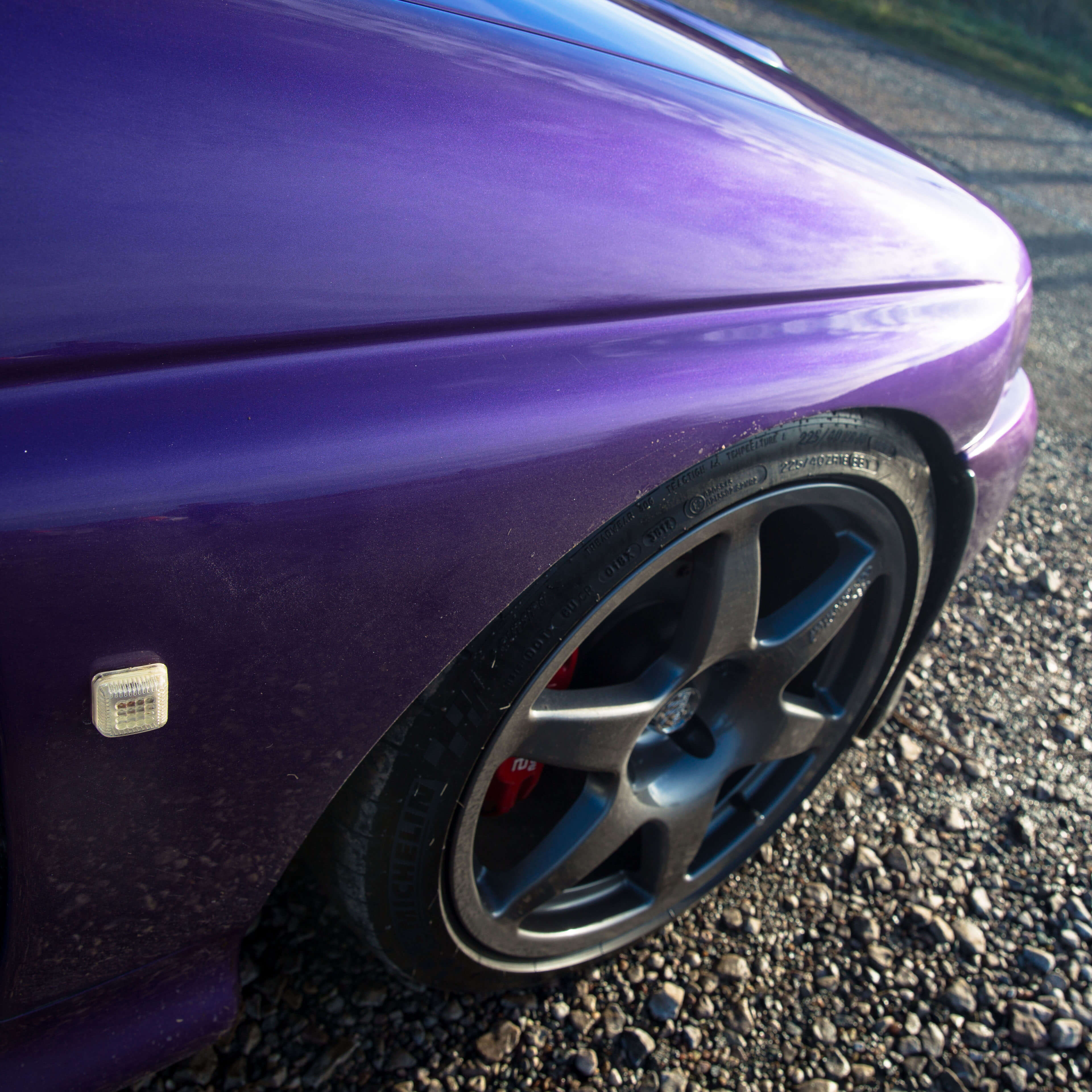 Purple Ford Escort front side view with wheel in shot