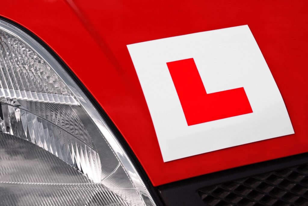 L plates on new red car