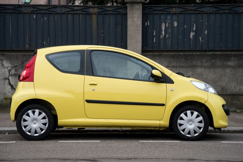 Yellow Peugeot 107 parked outside