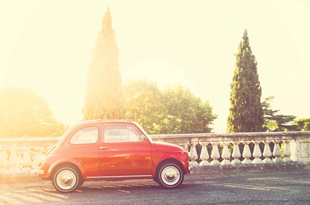 Old red Fiat 500 on beautiful street