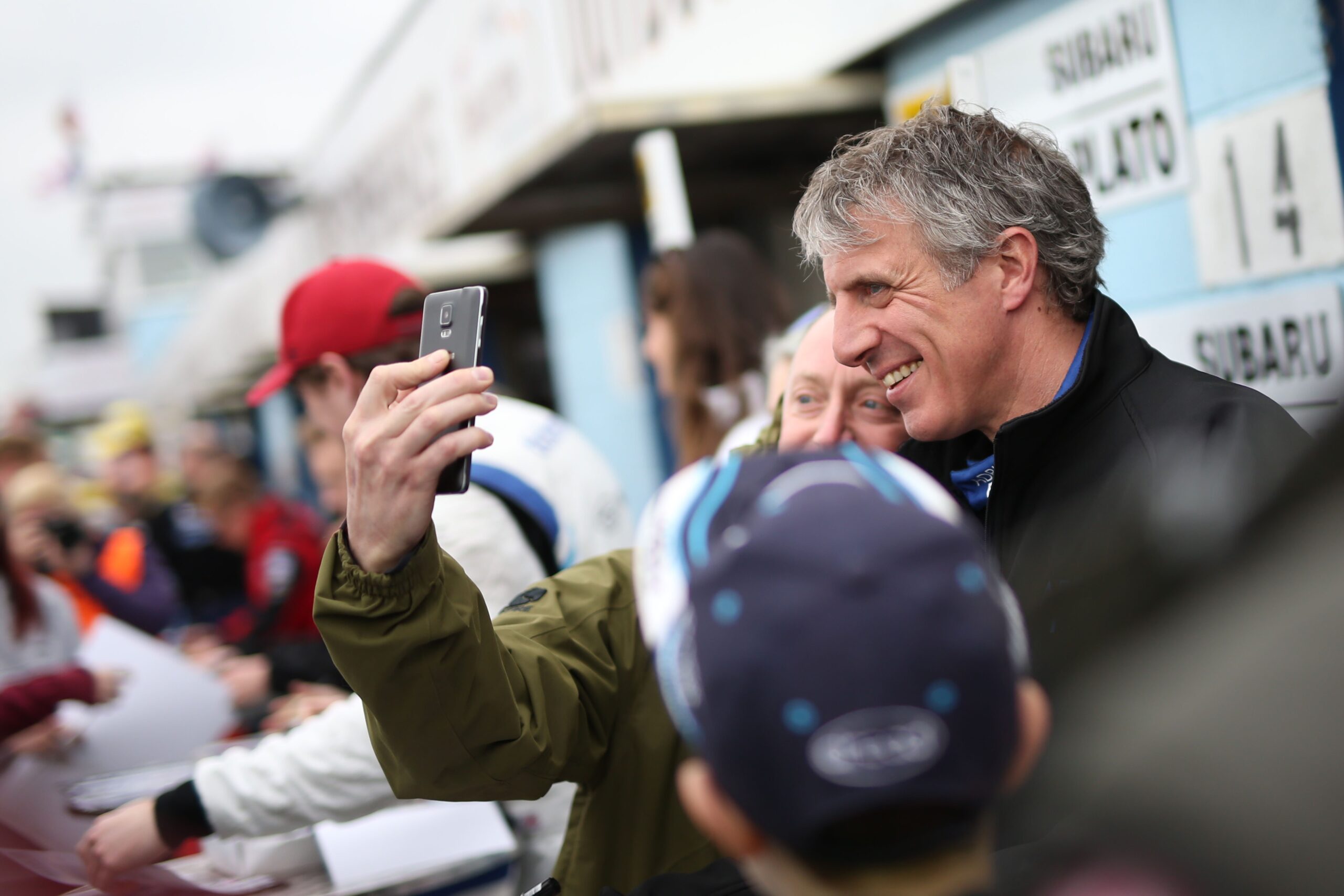 man taking selfie before adrian flux racing sponsorship event