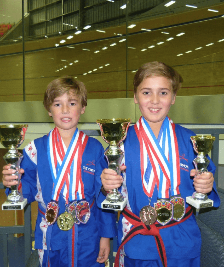 Jody, left, and Toby back show off some silverware during their taekwondo days.