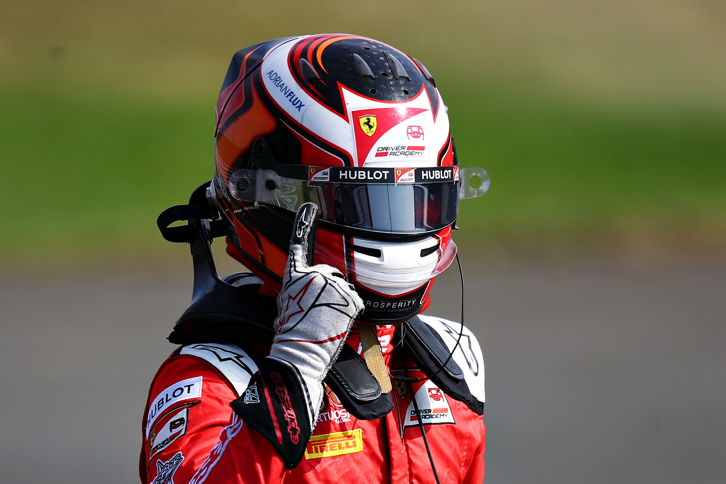 Callum Ilott puts his finger to his head while wearing a helmet