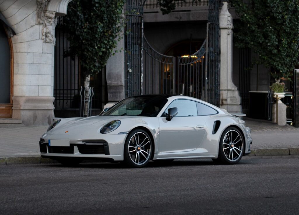Silver Porsche 911 Turbo parked in front of a building